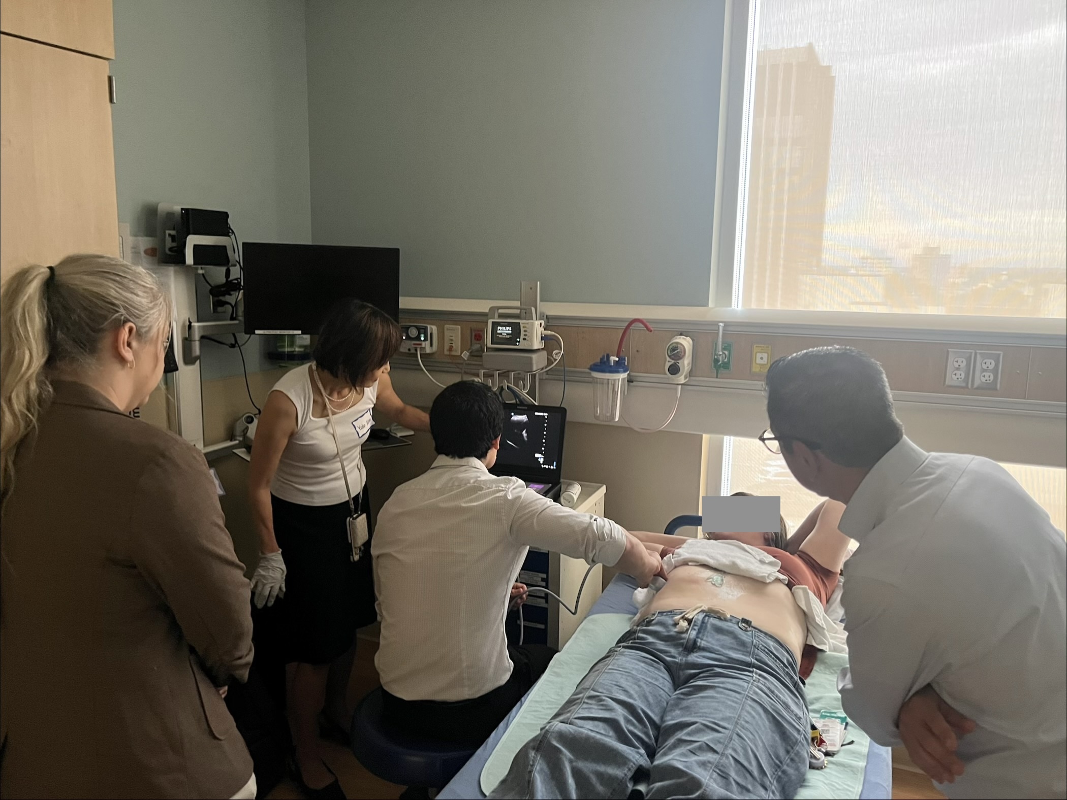 Image of Dr. Debes and others caring for patient